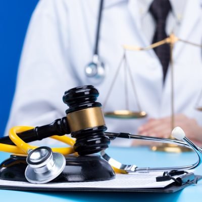 Stethoscope and justice mullet hammer is law protection for medical doctor to diagnose exam patient and lead to death. Hospital Insurance consider judgement safety with lawyer court judge, copy space